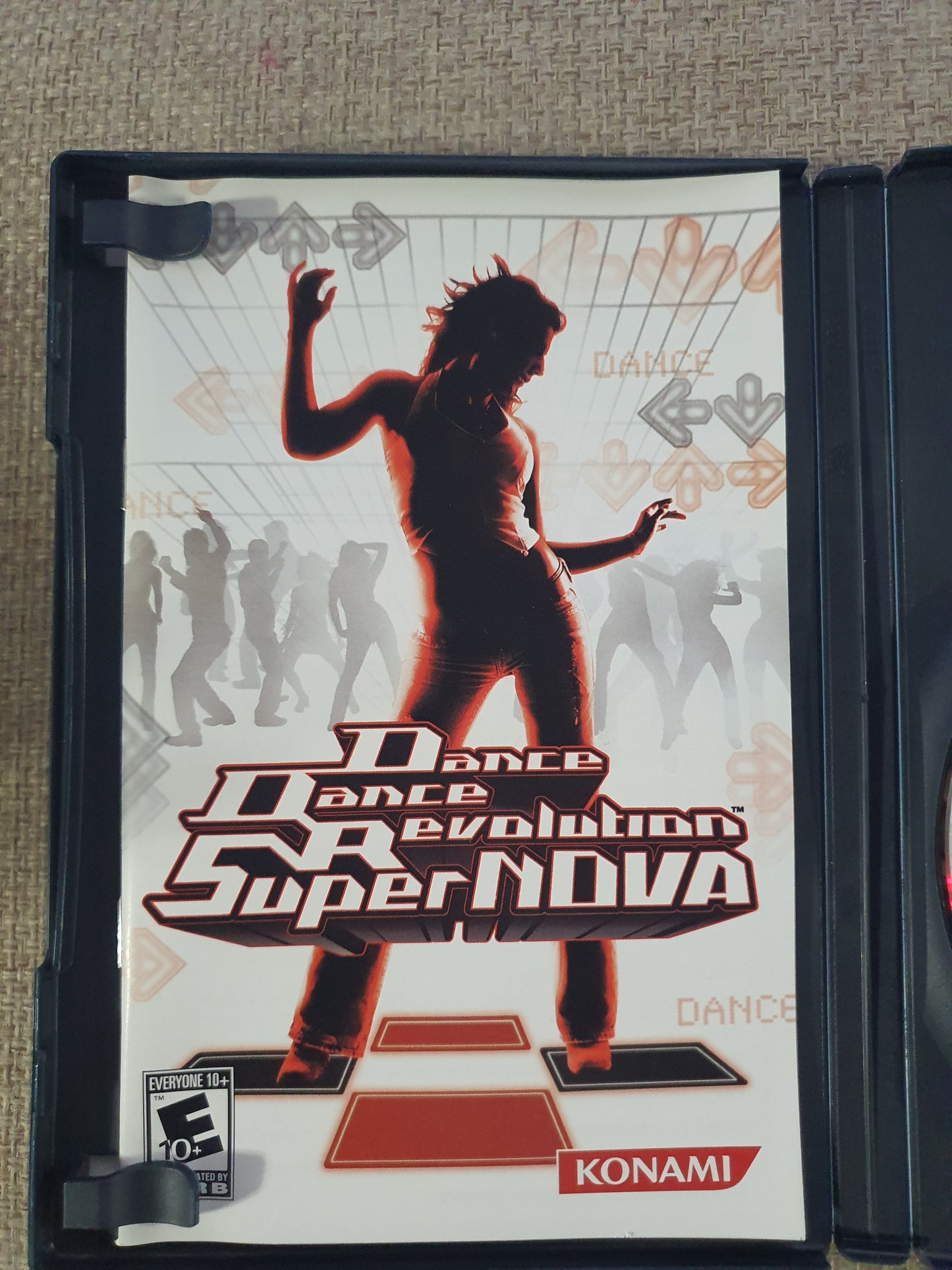 Dance Dance Revolution HyperNova game case on a textured surface