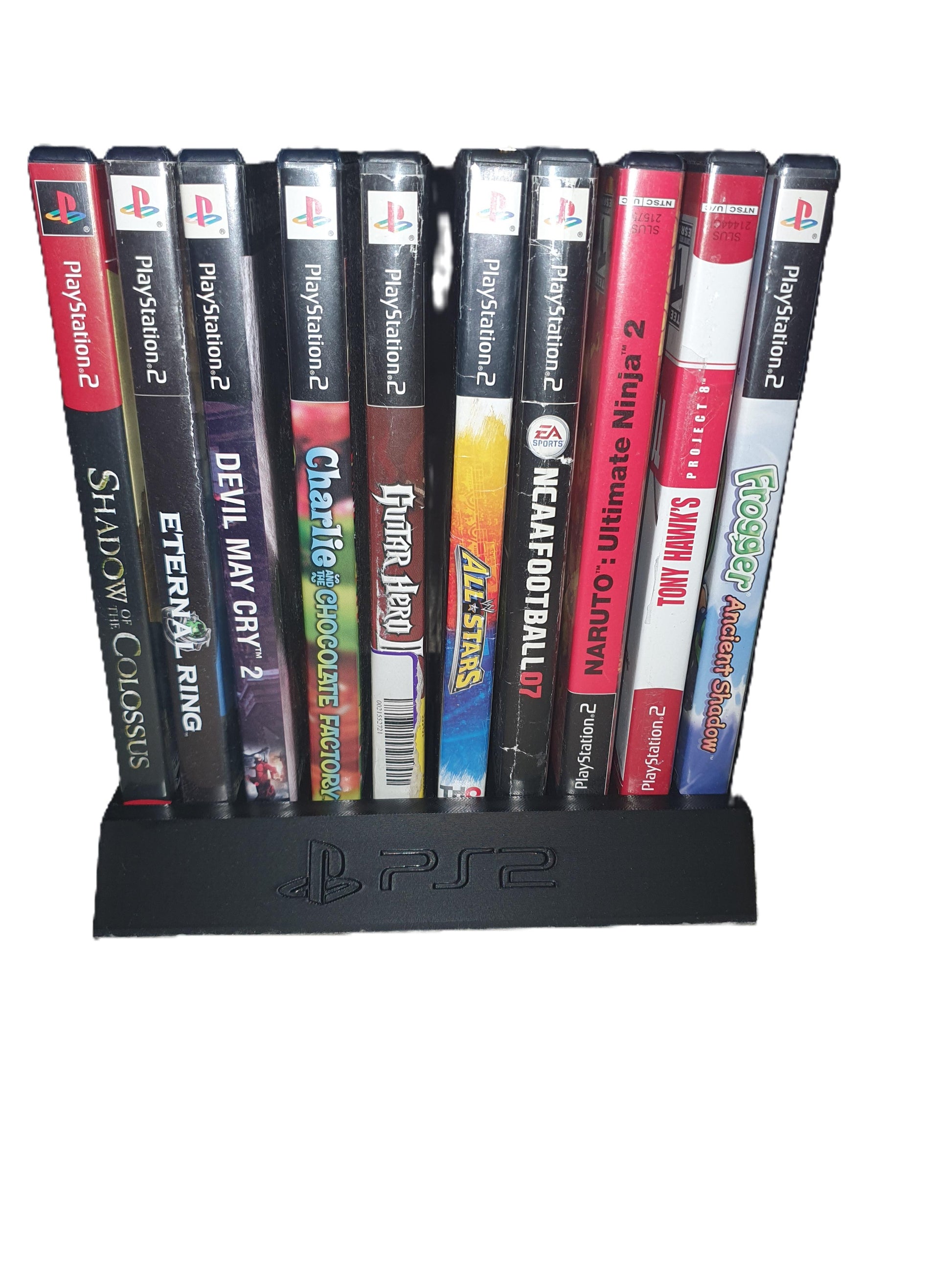 Collection of PlayStation 2 games on a black stand with visible branding.