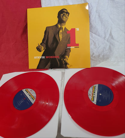 Red vinyl records with yellow cover featuring a person on a white background