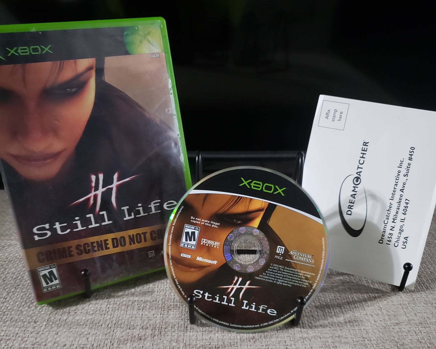 Xbox game disc and case on a textured surface