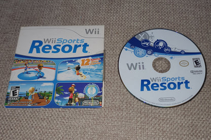 Wii Sports Resort game disc and cover on a textured surface